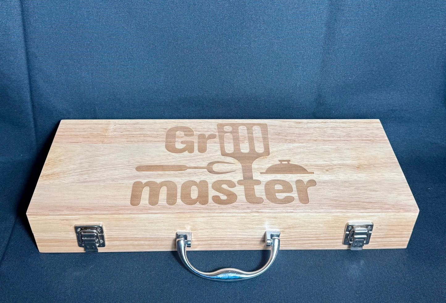 Grill Master engraved on top of the case. comes with a nice handle and a lock on either side other of the case to insure it won't open up.