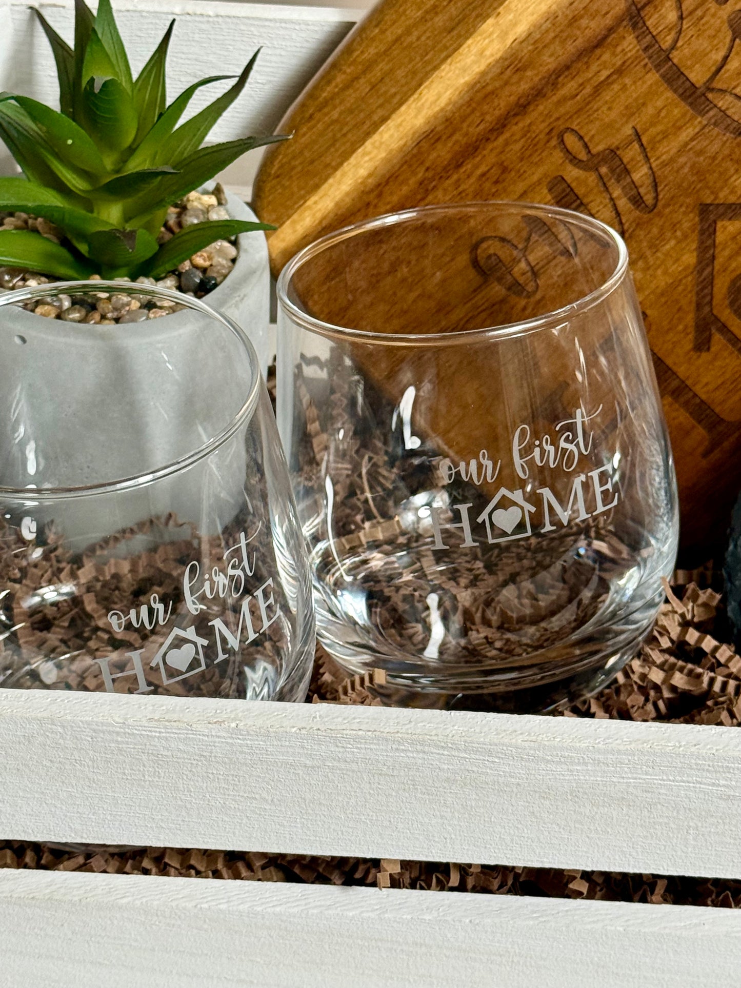 Two beautifully engraved wine cups, with a small plant.