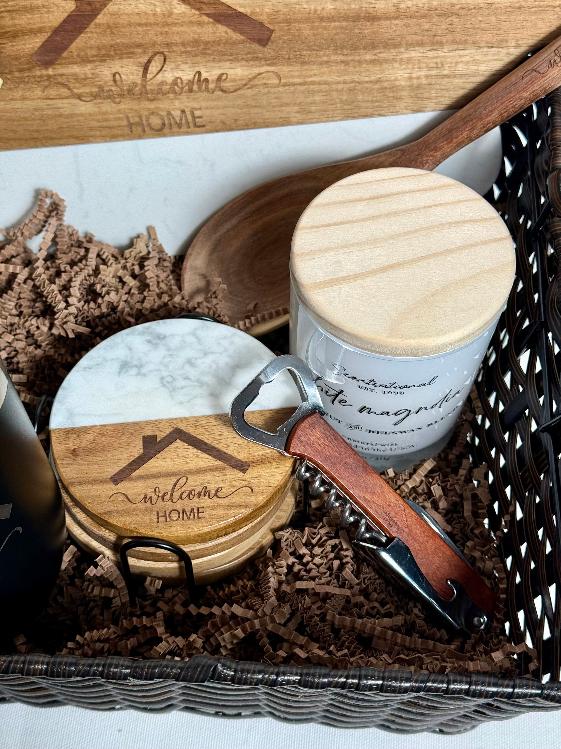 Decorative items including a wooden spoon, marble coaster set, candle, and bottle opener.