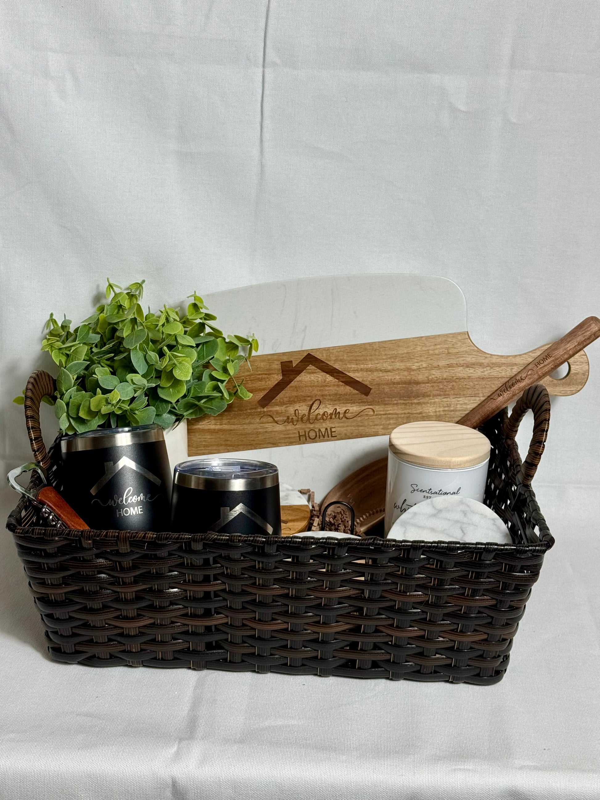 Beautiful white marble cutting board, matching coaster set, wine bottle opener, 2 wine tumblers, wooden spoon, and a plant.